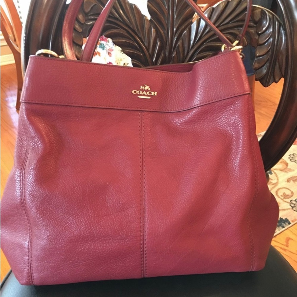 Coach Pebbled Leather 3 section bag in the color Crimson.